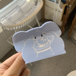Detail of light blue acetate hair claw clip with minimalist white cat line art pattern
