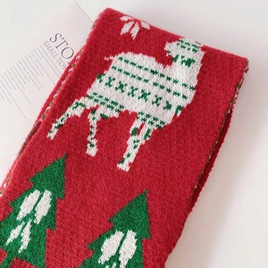 Winter red knitted scarf with white reindeer and green Christmas trees for children