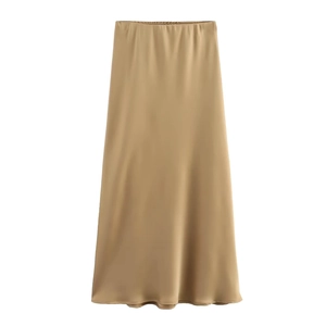 Detailed view of the elastic waistband on this champagne satin midi skirt