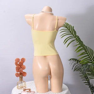 Back view of a yellow knitted halter top showing the hollow-out strap design