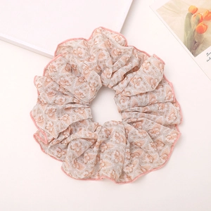 Retro floral print oversized scrunchie in beige and orange fabric with pink edging
