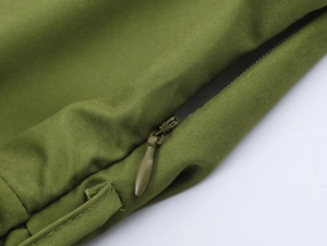 Detail of high-quality invisible green zipper and textured fabric on a French style dress