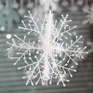 Macro shot of a 3D white tinsel snowflake ornament for Christmas tree decoration