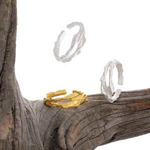 Artistic display of S925 sterling silver irregular textured rings on a wooden branch