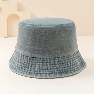 Close-up of denim bucket hat featuring detailed brim stitching and washed vintage texture