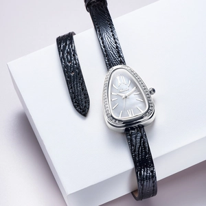 Detail of luxury silver snake head watch with diamond bezel and black leather strap