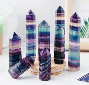 Detailed view of natural rainbow fluorite crystal hexagonal pillars in purple and green hues