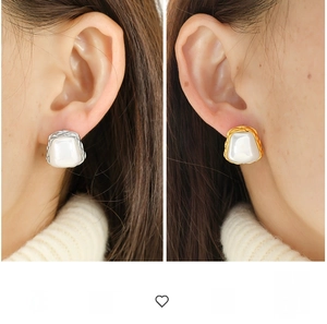 Detailed view of square geometric pearl earrings in gold and silver stainless steel