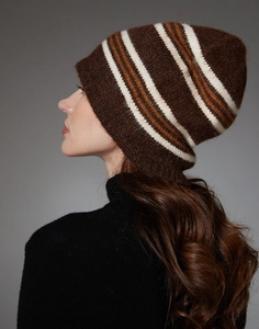 Detail view of a soft striped knit wool beanie in brown and white on a model