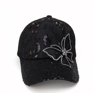 Close-up of black mesh baseball cap with sequined butterfly patch and floral embroidery