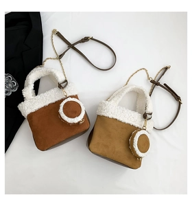 Detailed view of faux suede and shearling bucket bags with matching round coin purses