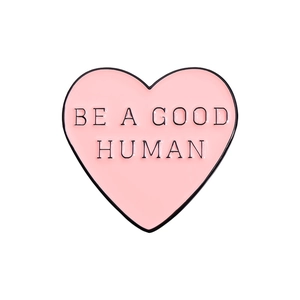 Pink heart enamel pin badge with Be A Good Human text in a minimalist geometric style