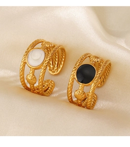 Macro shot of 18K gold plated steel ring with black and white enamel shell inlays