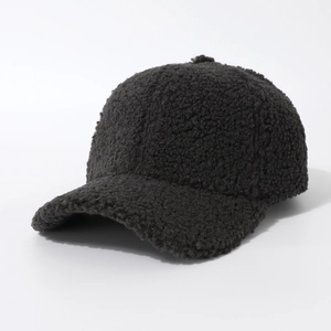 Close-up of thick grey sherpa fleece texture on a warm winter baseball cap