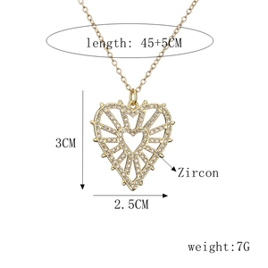 Detail view of gold zircon heart pendant with dimensions 3x2.5cm and 45+5cm chain length
