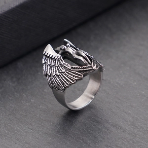 Close-up of vintage silver angel wing ring with detailed metal carving and relief