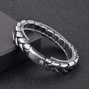 Detailed macro view of 11mm silver stainless steel wheat chain bracelet on display box