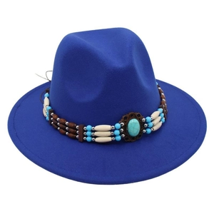 Detail of bohemian royal blue fedora with turquoise beaded band and vintage stone