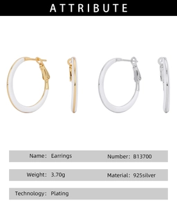 Detailed view of large 925 silver hoop earrings with white enamel and gold plating