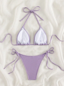 Flat lay of lavender ribbed bikini set featuring halter triangle top and side-tie bottoms