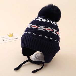 Detailed knit texture of navy blue kids trapper hat with pompom and earflaps