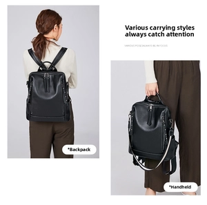 Detail of a black pebbled leather backpack showing dual carrying ways: shoulder and handheld