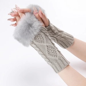 Macro detail of knit fingerless arm warmers with grey faux fur trim and cable patterns