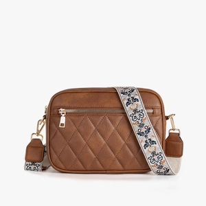 Brown quilted crossbody bag featuring ethnic style embroidered wide shoulder strap