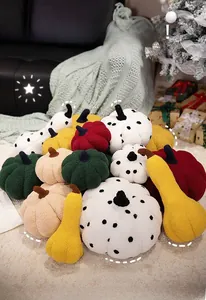 Plush pumpkin pillows in various colors and shapes on a cozy living room rug
