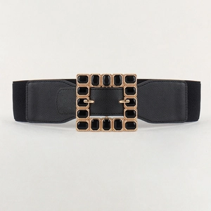 Detail of a large square golden buckle with black rhinestones on a 6cm wide elastic belt