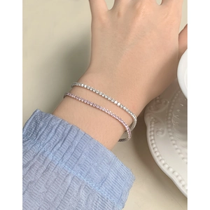 Elegant S925 sterling silver tennis bracelets in silver and pink on a woman wrist