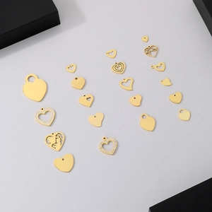 Golden stainless steel heart pendants in various hollow and crystal-encrusted designs