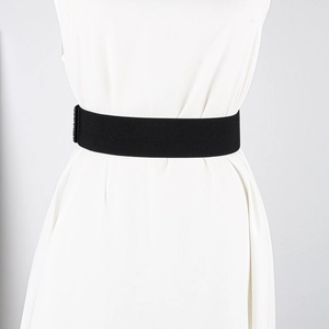 Close-up of a wide black elastic waist belt with high-density fabric on a white dress