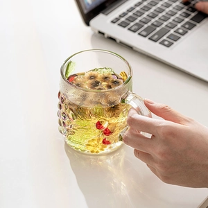 Hand-painted glass mug with floral patterns and handle, perfect for coffee and herbal tea