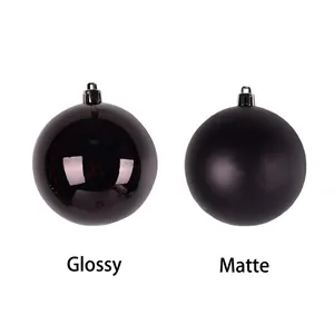 Glossy and matte black Christmas baubles with hanging caps on white background