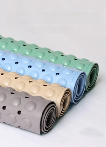 Detail of rolled anti-slip bathroom mats with massage texture and drainage holes