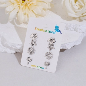 Detail of 4-pair silver stainless steel stud set with flower and dandelion designs