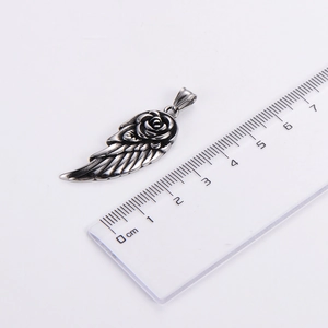 Detailed size measurement of silver feather and rose petal pendant with a CM ruler