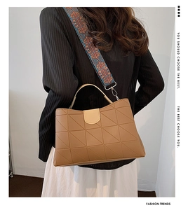 Brown leather tote with geometric quilting and a colorful ethnic wide woven strap