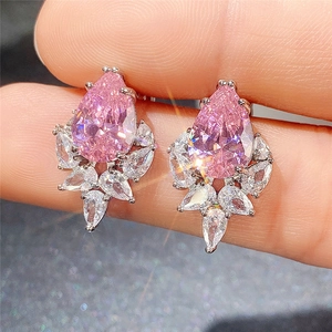 Macro shot of pink pear-cut zircon earrings with white marquise diamond accents