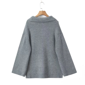 Detailed back view of a grey oversized knit sweater showing vertical ribbed texture