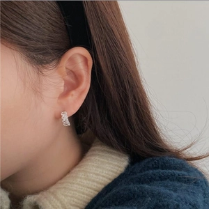 Elegant 925 sterling silver hoop earrings with cubic zirconia worn by a model