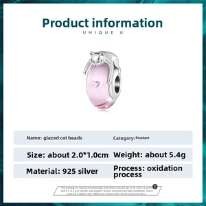 Detailed macro view of 925 sterling silver pink glass cat charm with heart gemstone