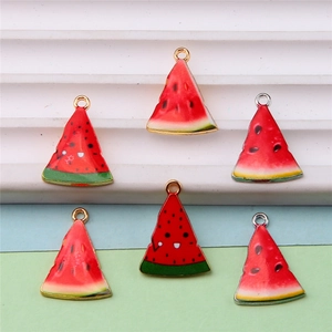 Detailed close-up of a red and green watermelon-shaped enamel charm for DIY jewelry making