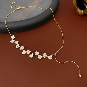 Detail of gold plated necklace featuring floral accents and adjustable sliding chain clasp