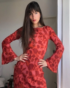 Detail of the dark red floral print on a long-sleeved dress with flared cuffs