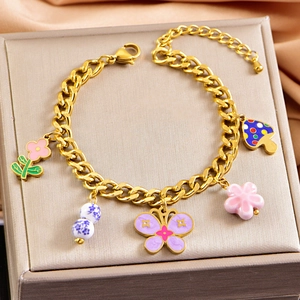 Golden chunky chain bracelet with colorful butterfly flower and porcelain charms