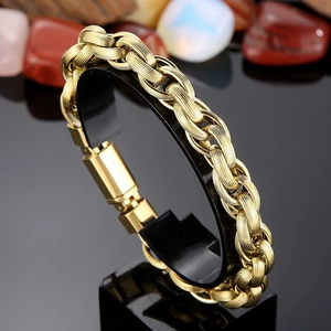 Close-up of golden woven link bracelet with thick spiral texture and snap buckle clasp