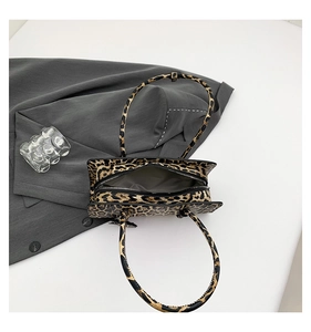 Macro shot of stylish leopard print texture and zipper detail on the crossbody handbag