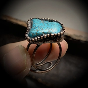 Adjustable bronze open ring featuring an irregular turquoise stone and spiral band